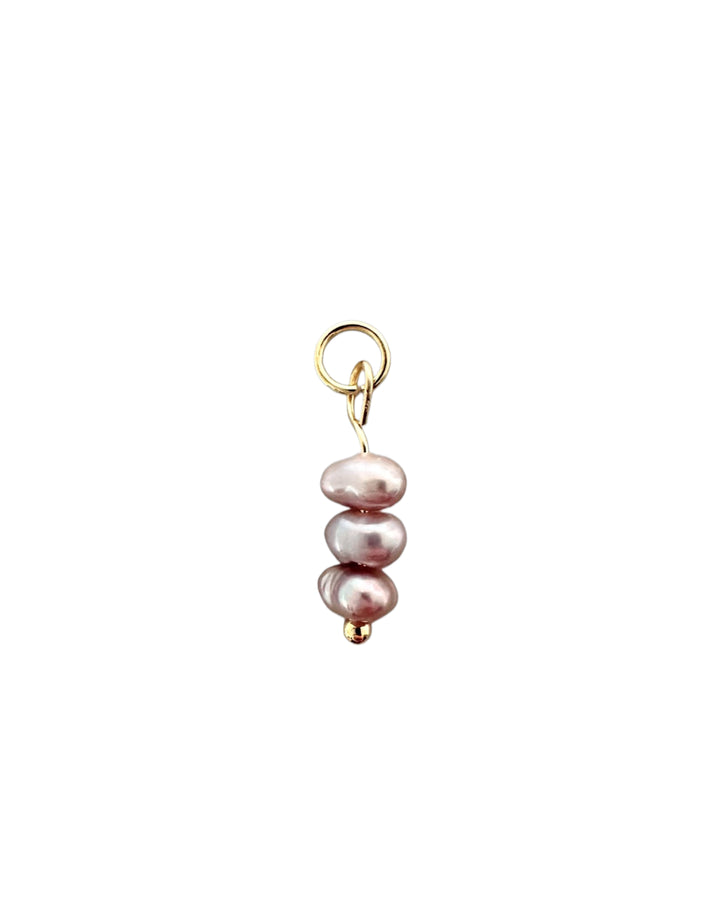 3 Pearl charm with gold ring on a white background