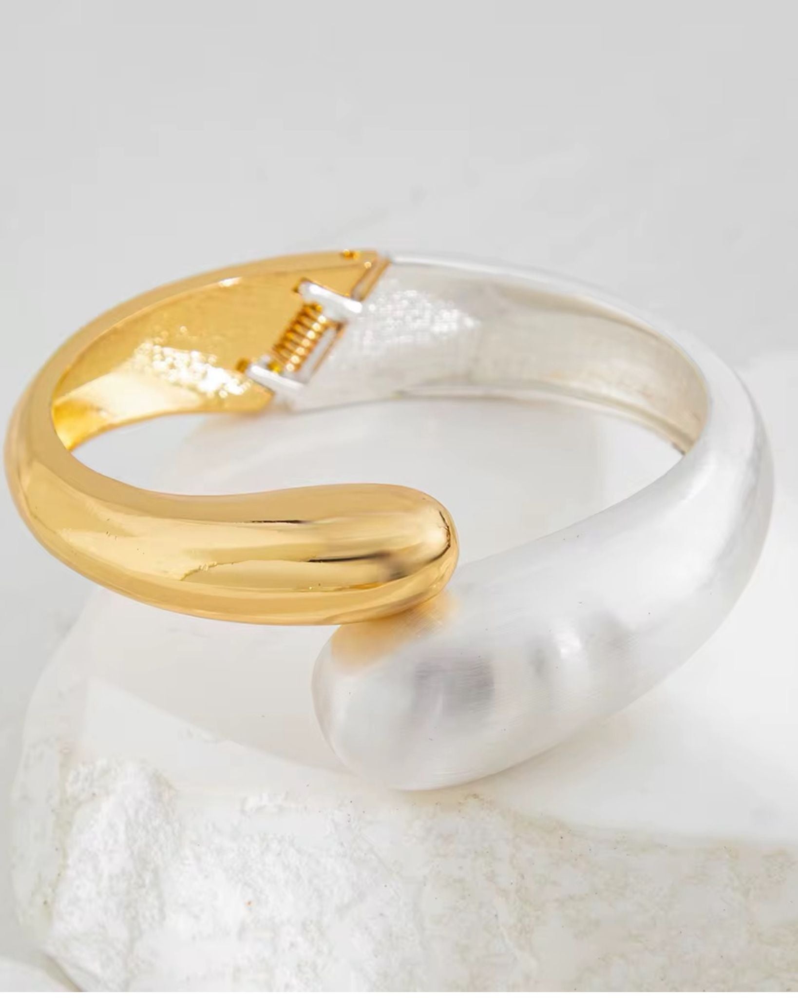 Gold and silver open ring on a white background