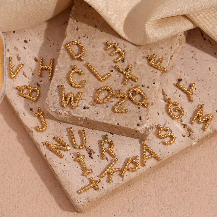 TWISTED LETTER CHARM