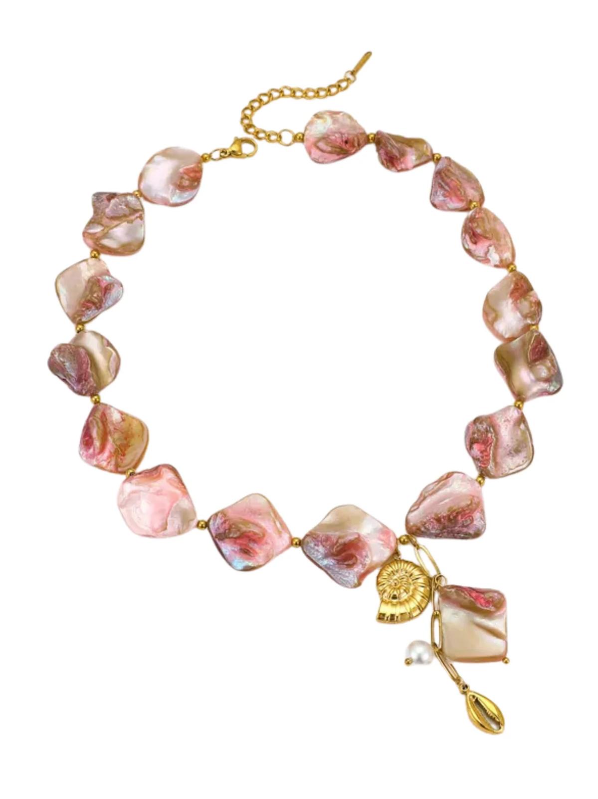 A matching necklace and bracelet set with gold plating and natural shell beads, featuring a sun motif charm.