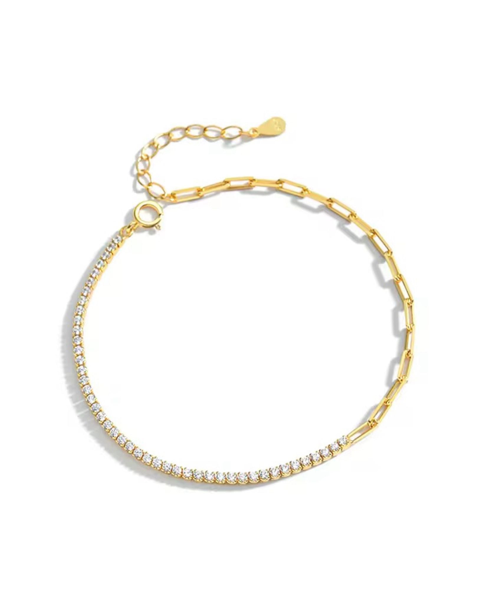 Gold tennis zircon paper-clip bracelet with clear stones on a white background