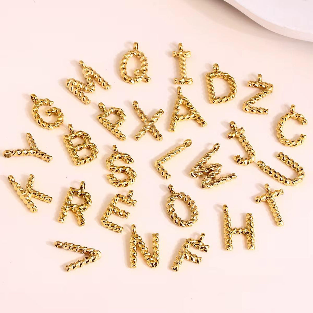 TWISTED LETTER CHARM