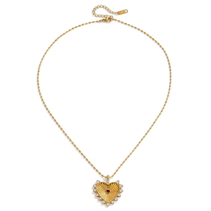 Gold heart-shaped necklace with a red center for her