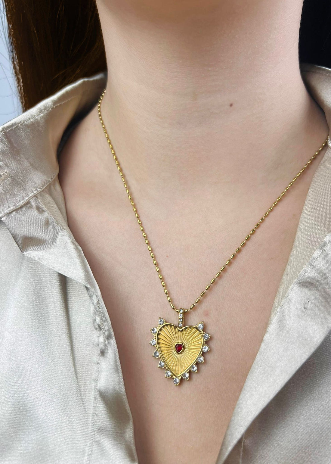 Gold necklace with a heart-shaped pendant for her