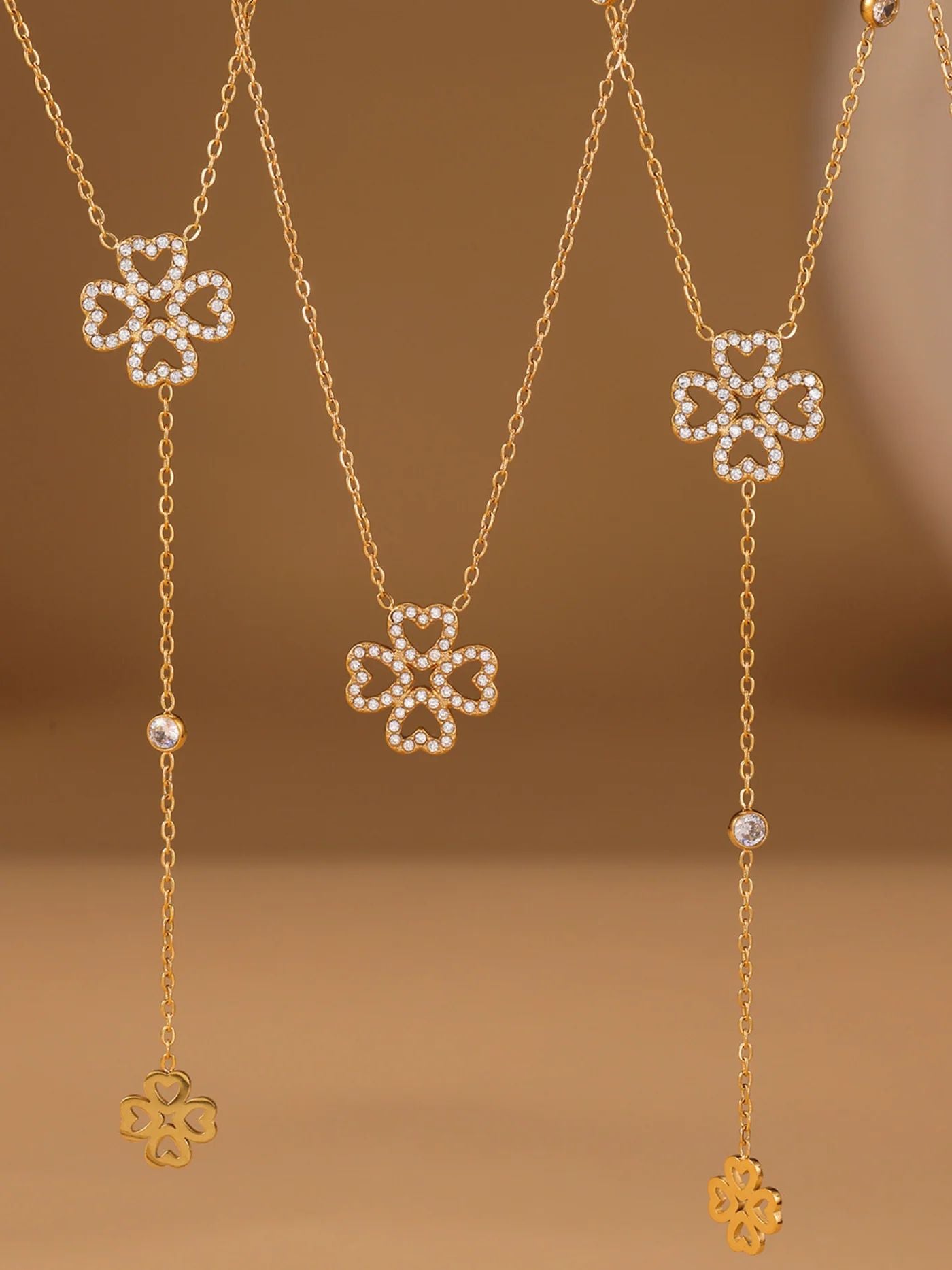 Gold necklace with clover pendants for her