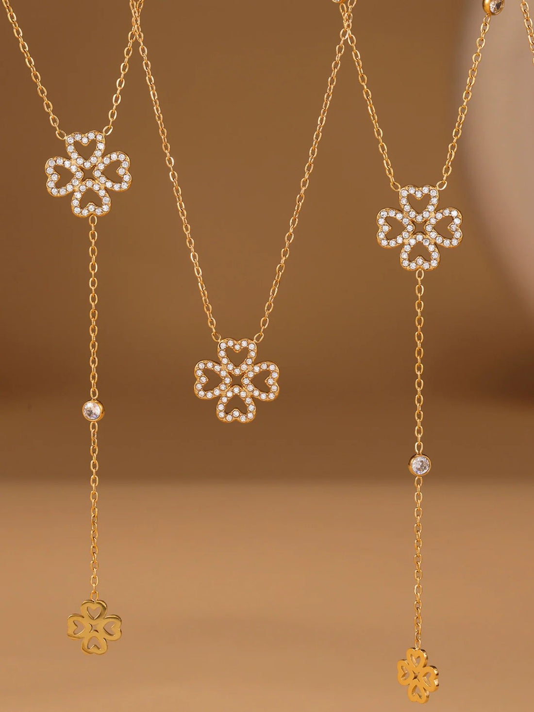 Gold necklace with clover pendants for her