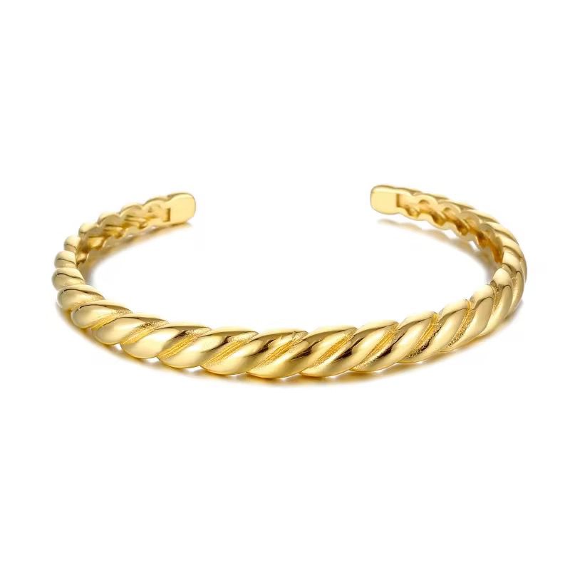 abstract gold bangle on a white background