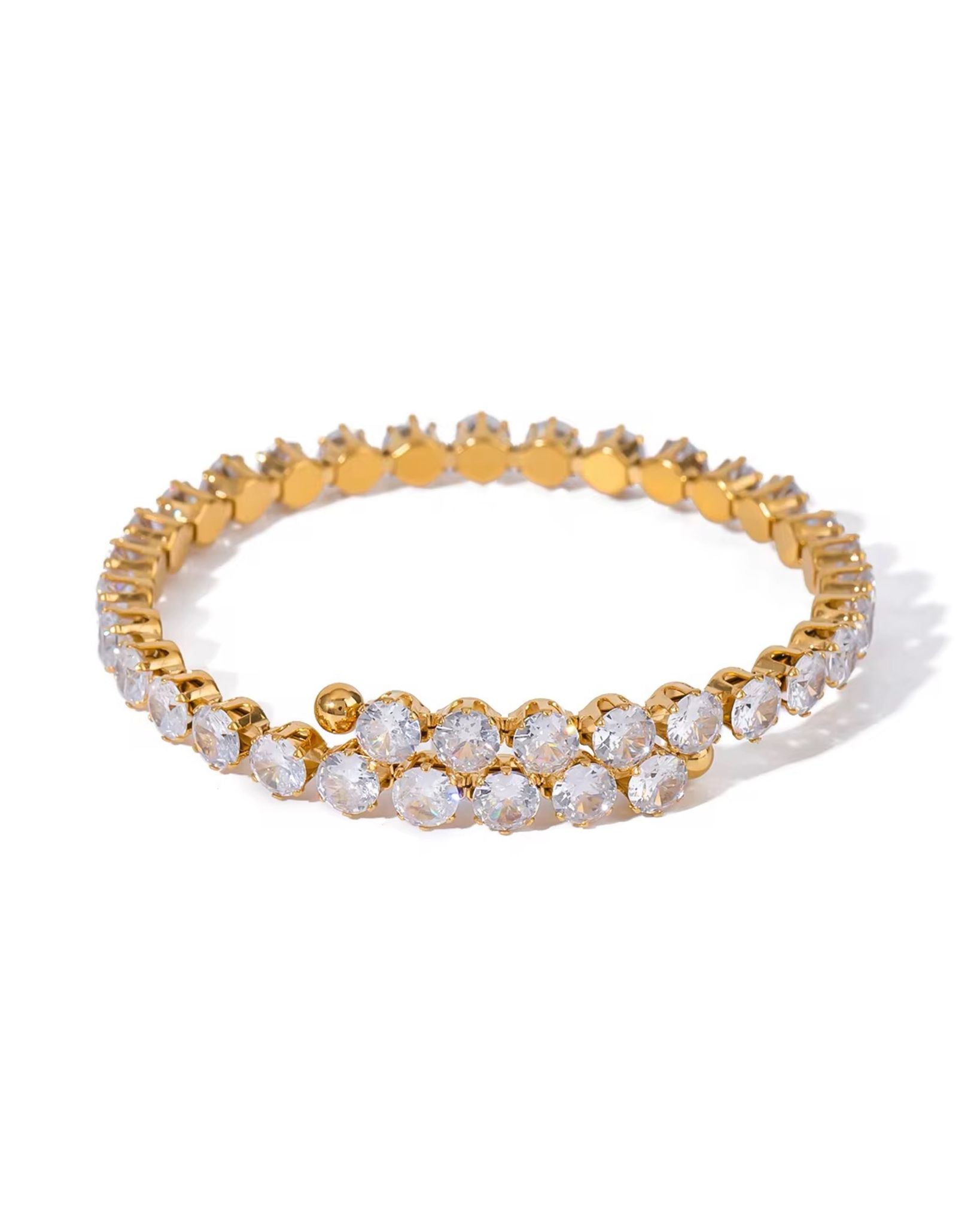 Gold and diamond amiri zircon bracelet on a white background