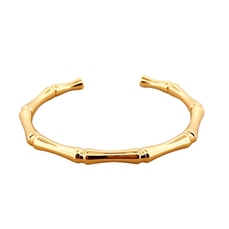 Gold bamboo-style bracelet on a white background