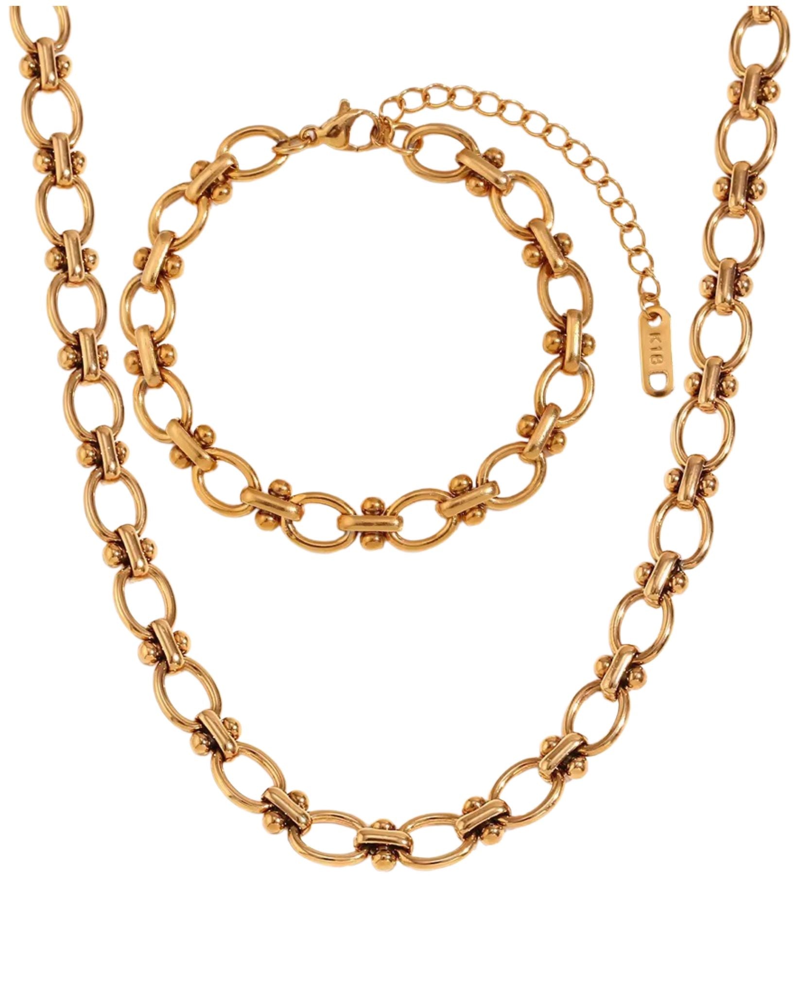 Gold block chain necklace and bracelet set on a white background