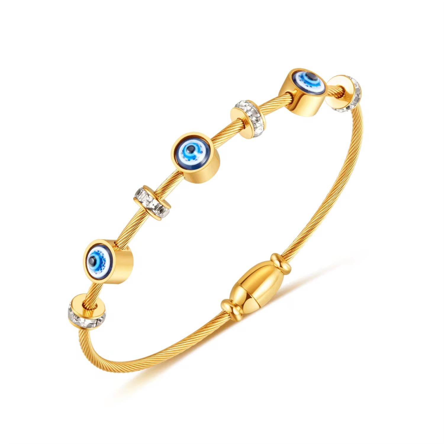 An 18k gold plated stainless steel danitly evil eye bracelet with blue and white stone embellishments.