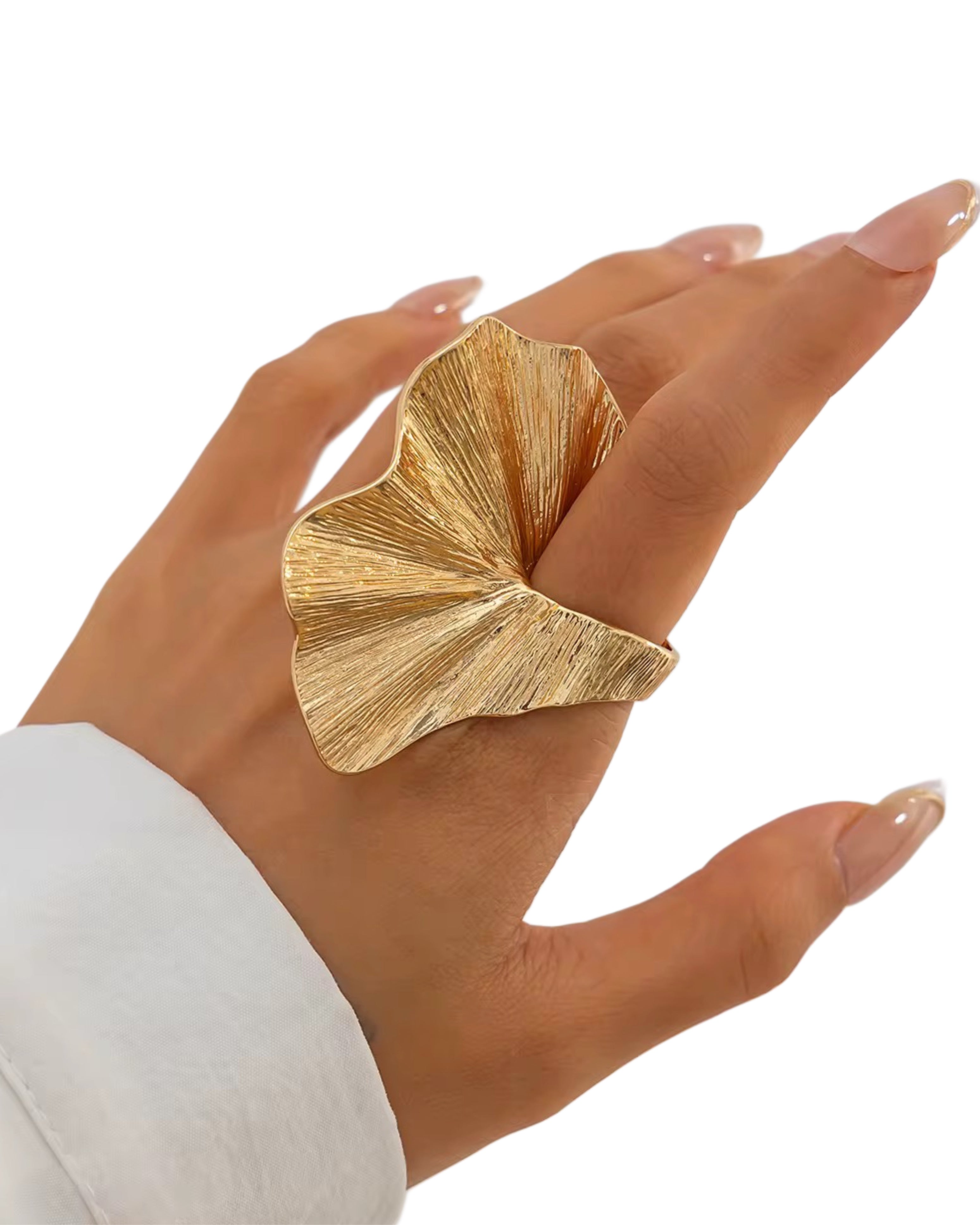 Gold leaf-shaped edith ring on a hand with a white sleeve against a white background
