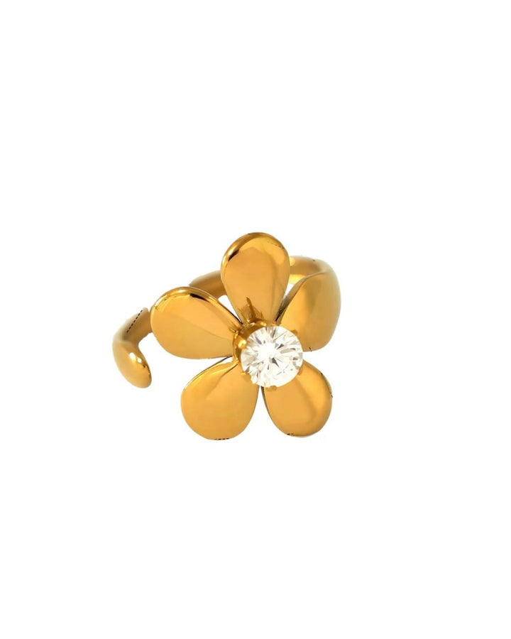 Gold flower zircon ring with a clear gemstone on a white background