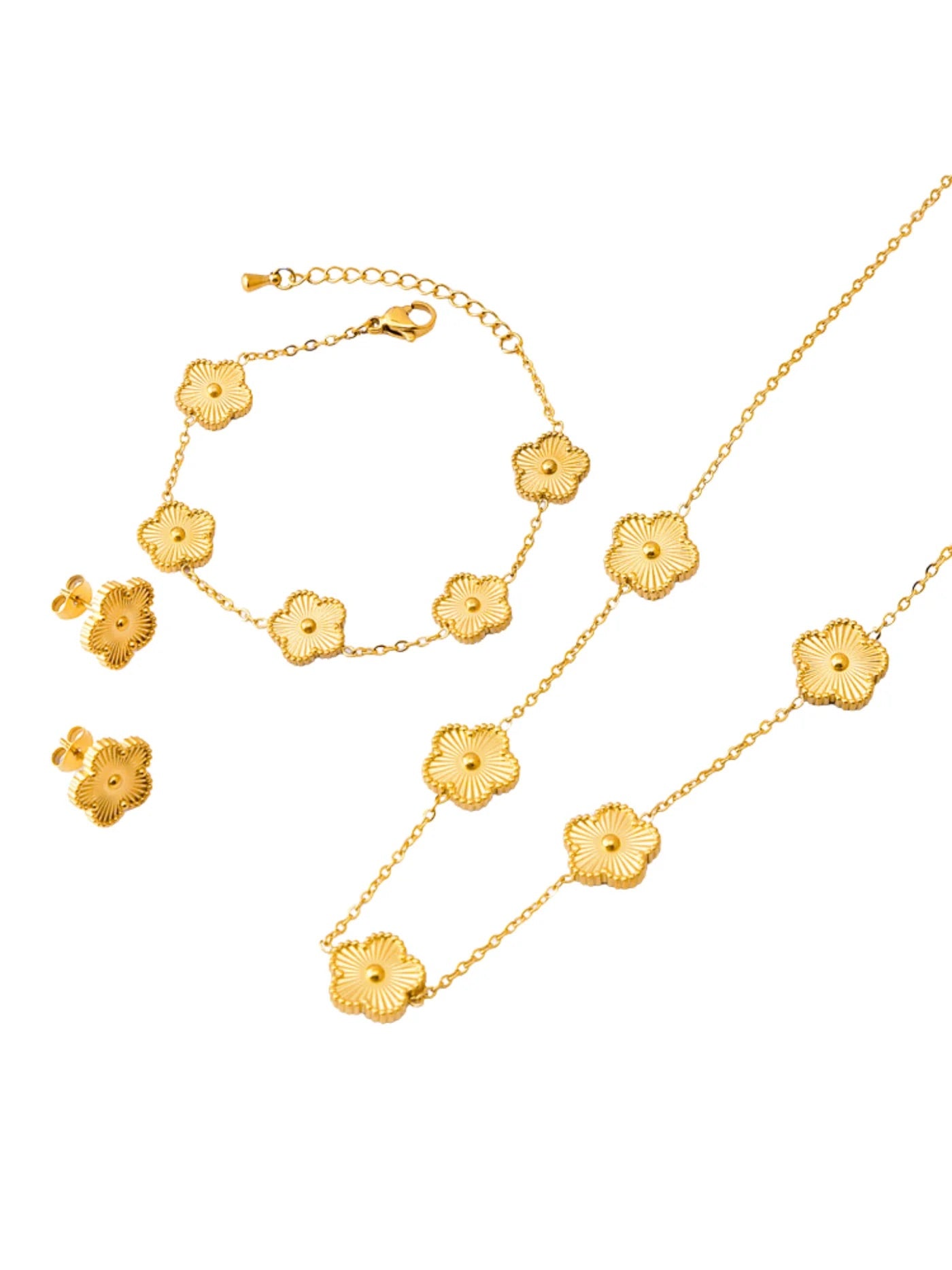 A set of gold-colored jewelry including a necklace, bracelet, and earrings, featuring clover leaf designs.