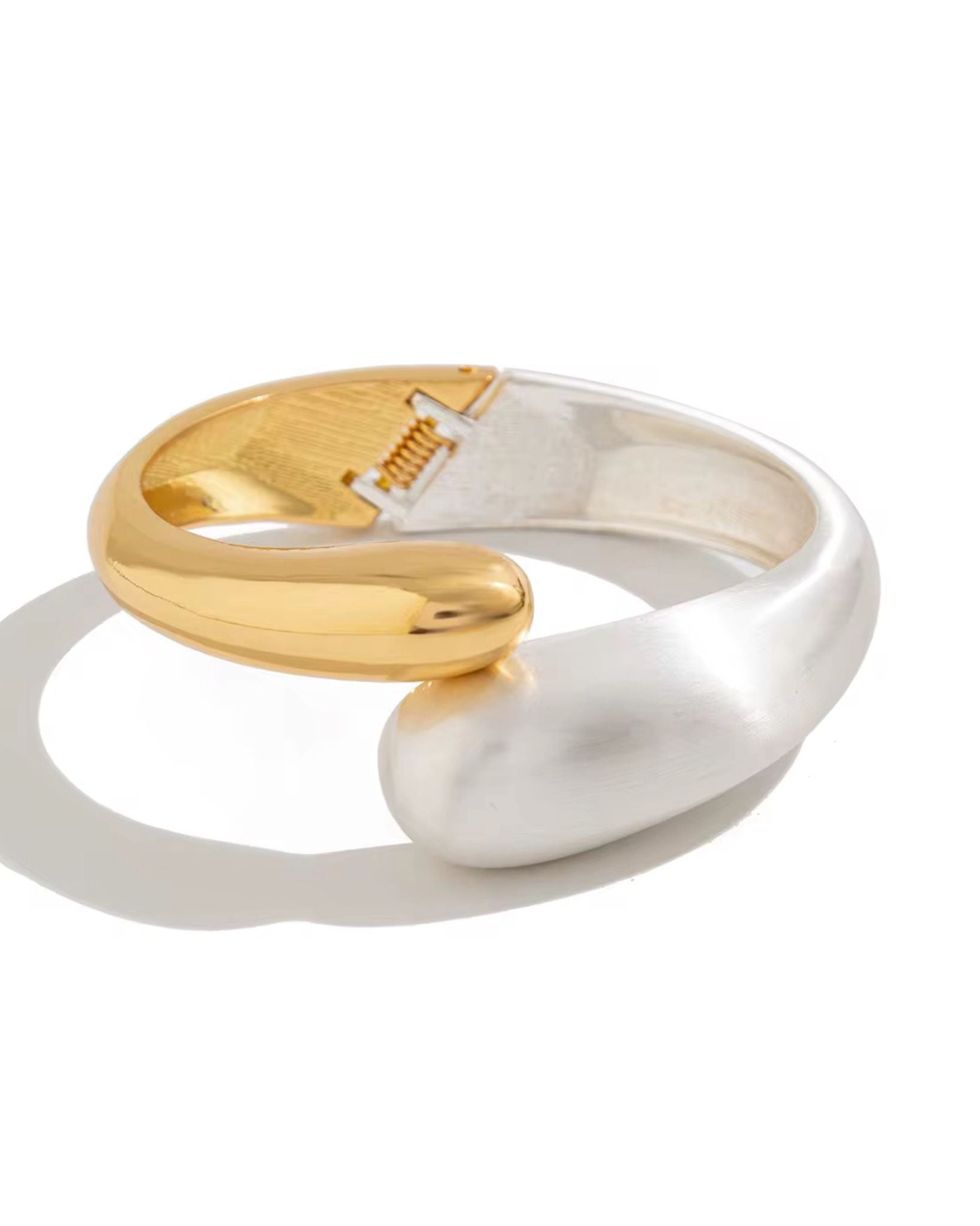 Two gold and silver rings on a white background