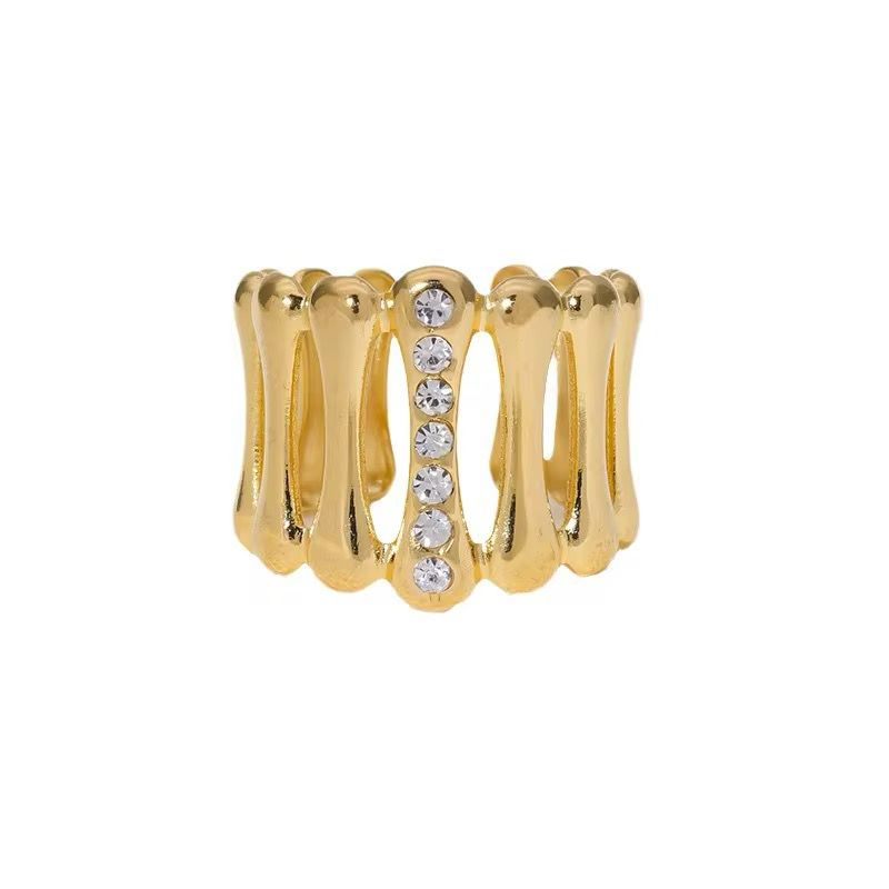 An 18K gold plated stainless steel jane ring with an adjustable size and a row of small, round, clear crystals in the center.