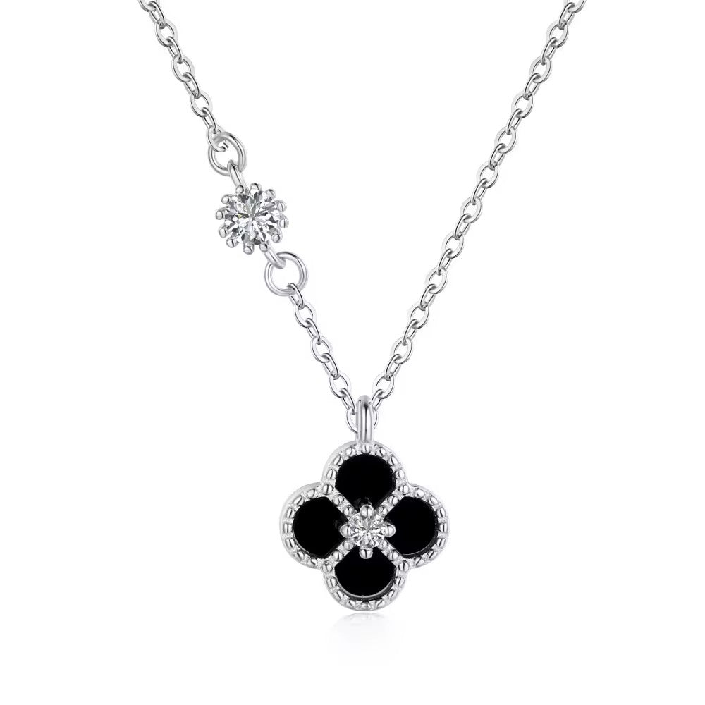 A sterling silver liana clover necklace with a black and silver clover-shaped pendant, featuring zircon stones on the chain and clover.