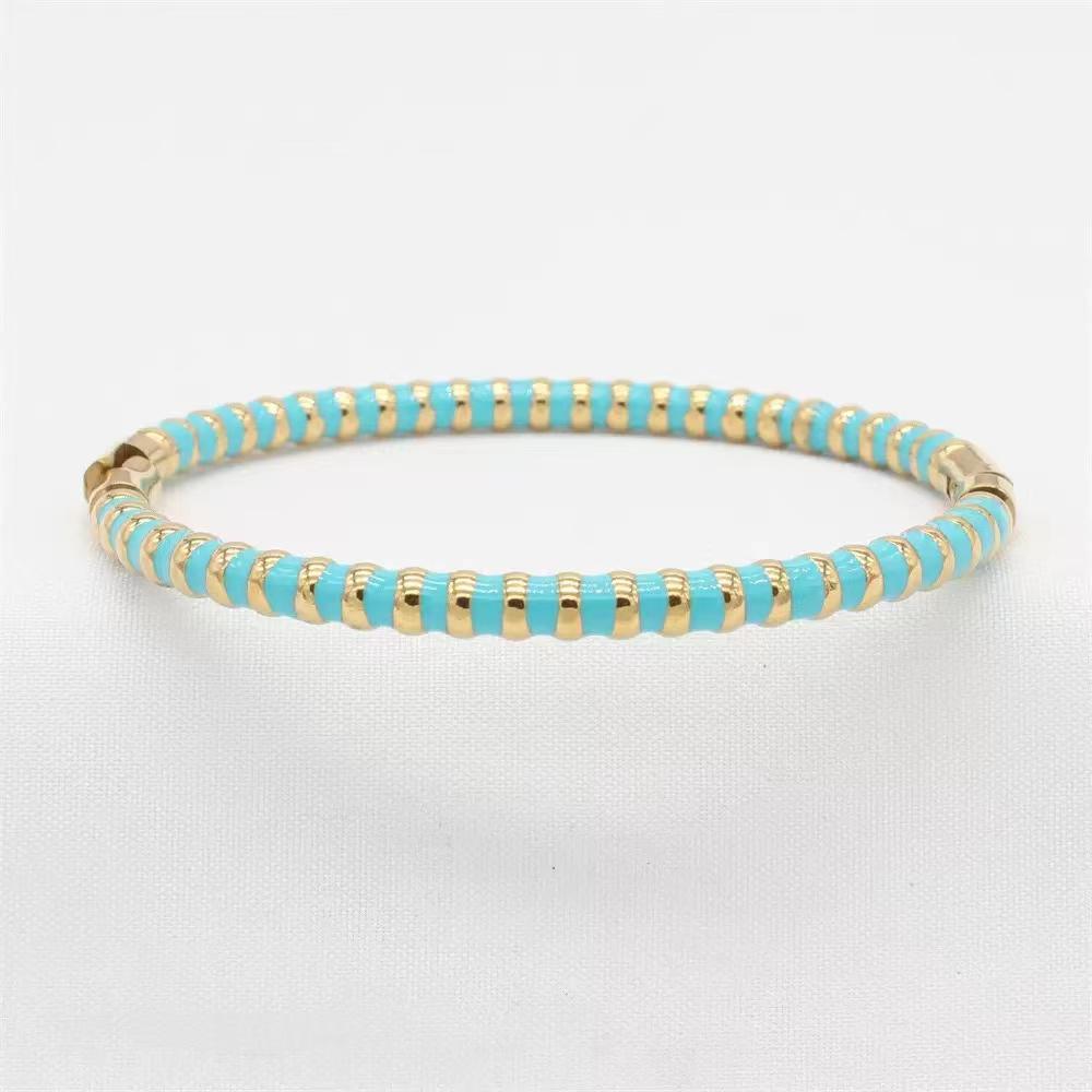gold beaded lida blue bangle on a white background