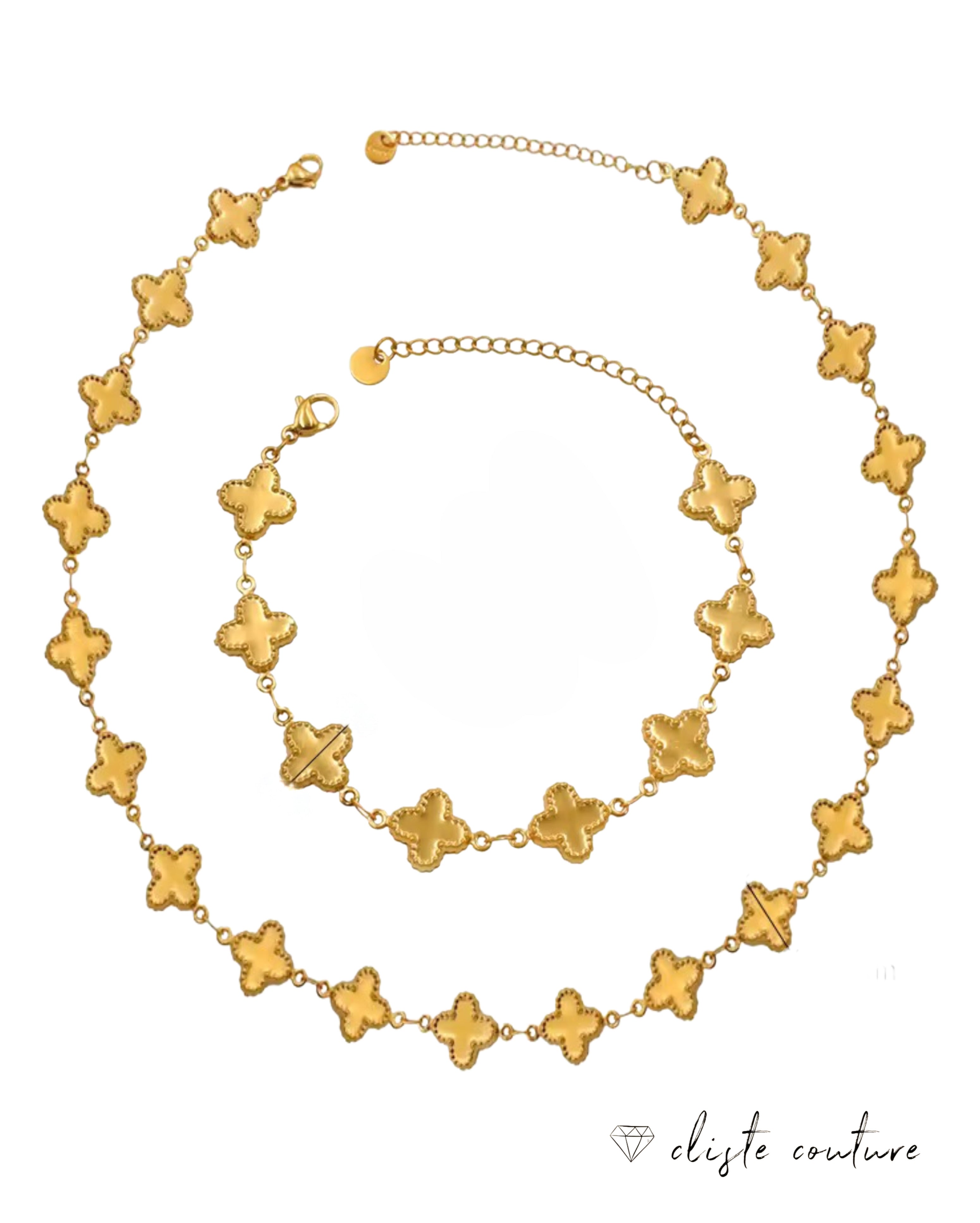 Gold necklace with clover-shaped links on a white background, branded 'eliste couture'.