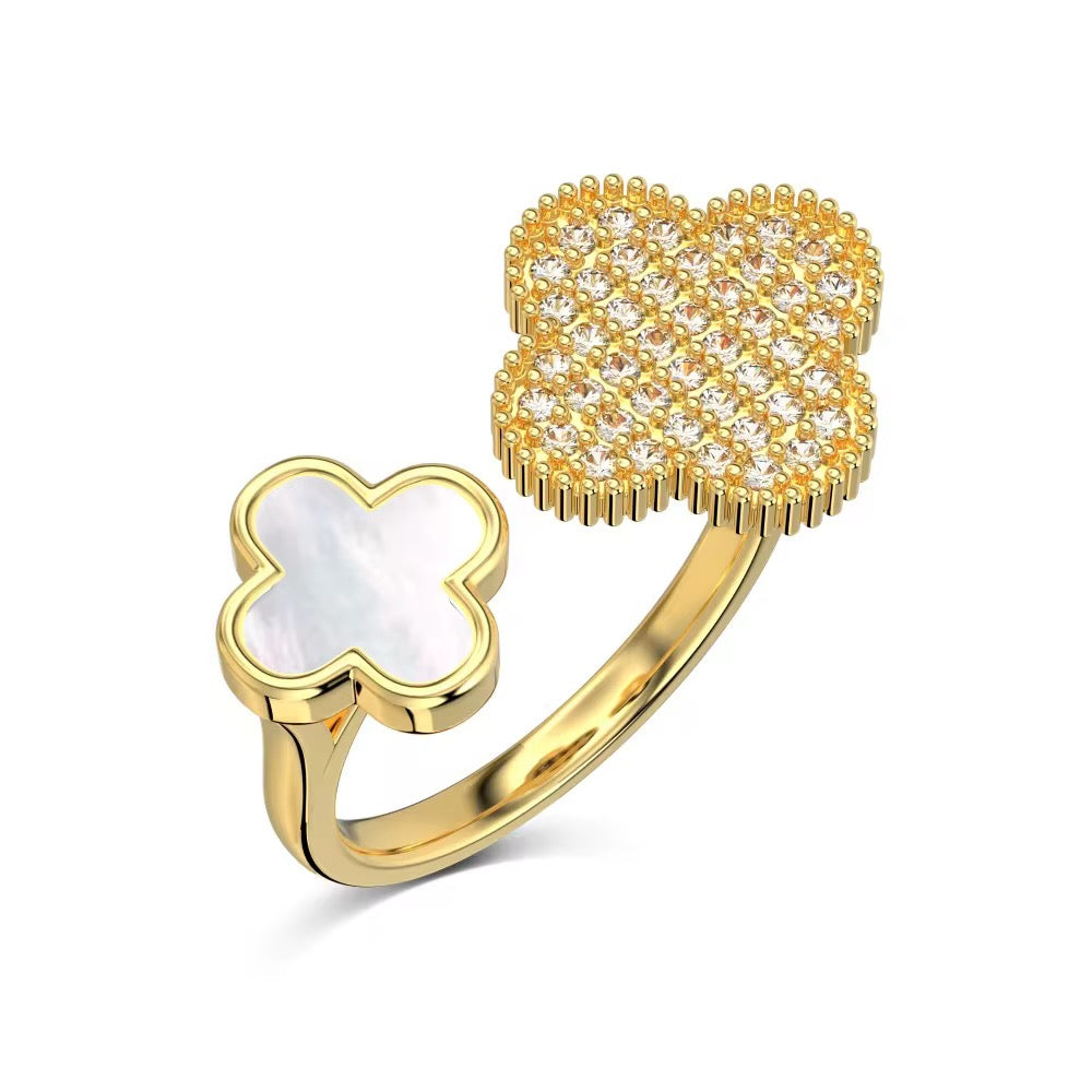 A gold-colored orabella clover ring with a clover-shaped design, featuring a central zirconia-studded clover with a mother-of-pearl clover on the side.