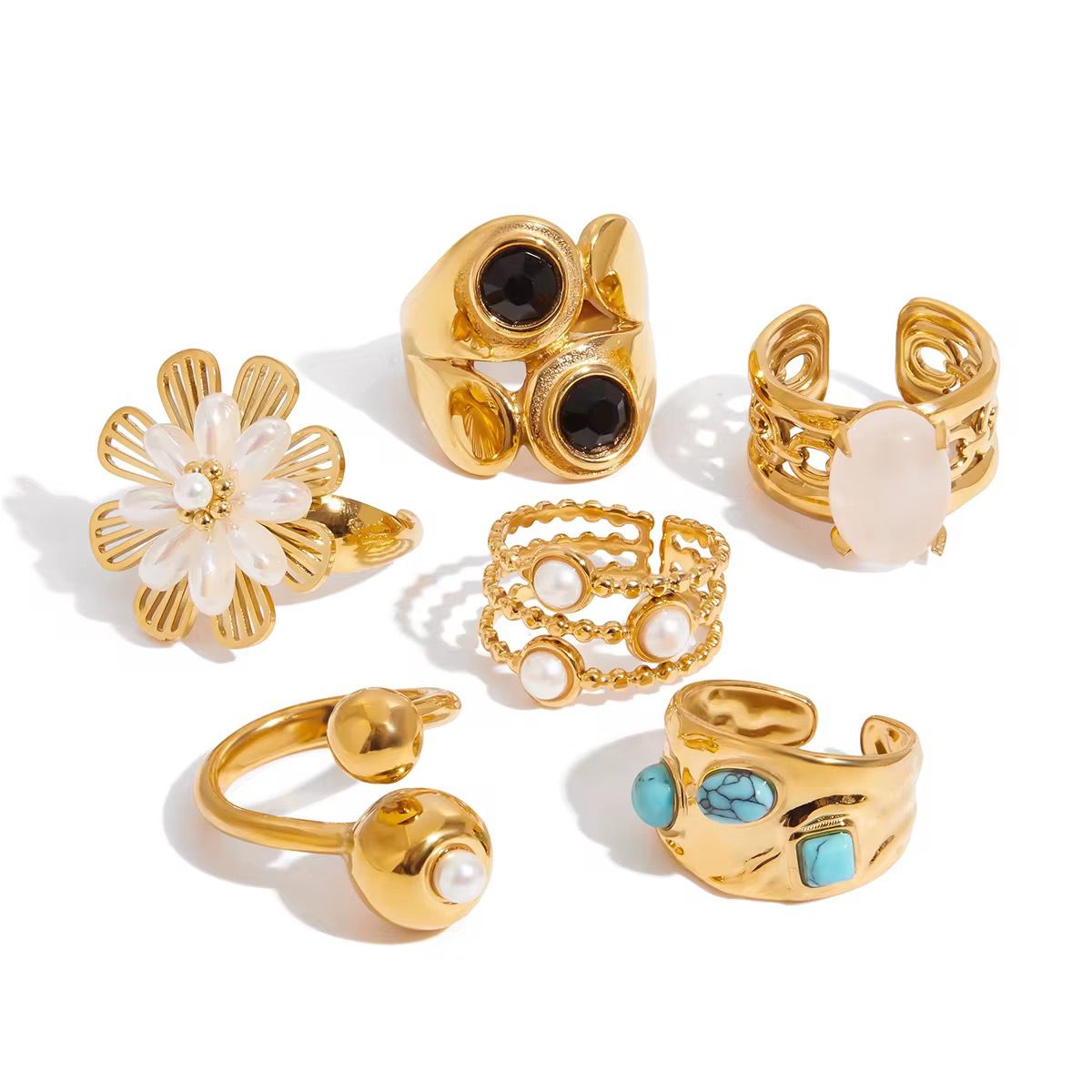 Set of gold rings with various designs on a white background