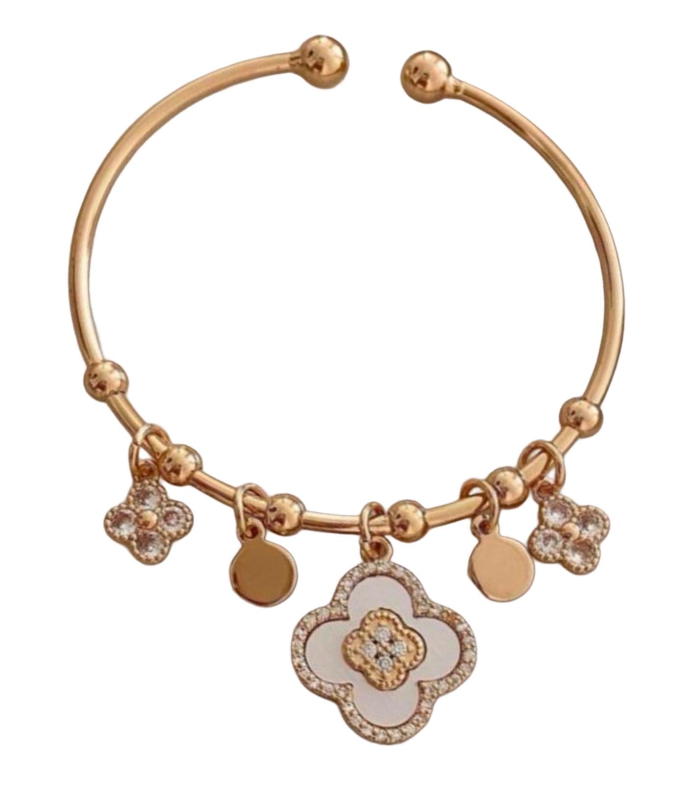 An 18K gold  plated stainless steel bria clover bracelet with white and multicolor zirconium clover and heart charms.