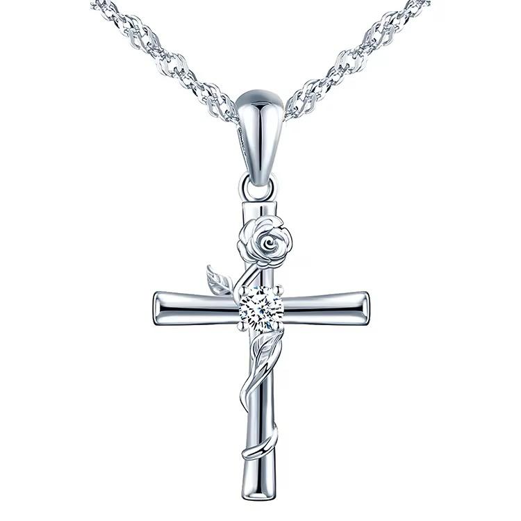 A silver tamara necklace featuring a floral cross pendant with a chain link.