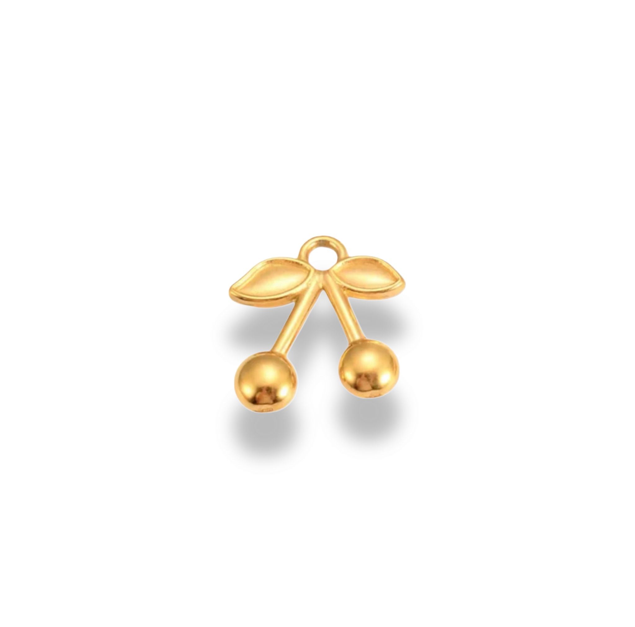 A gold-colored charm in the shape of two cherries connected by a jump ring.