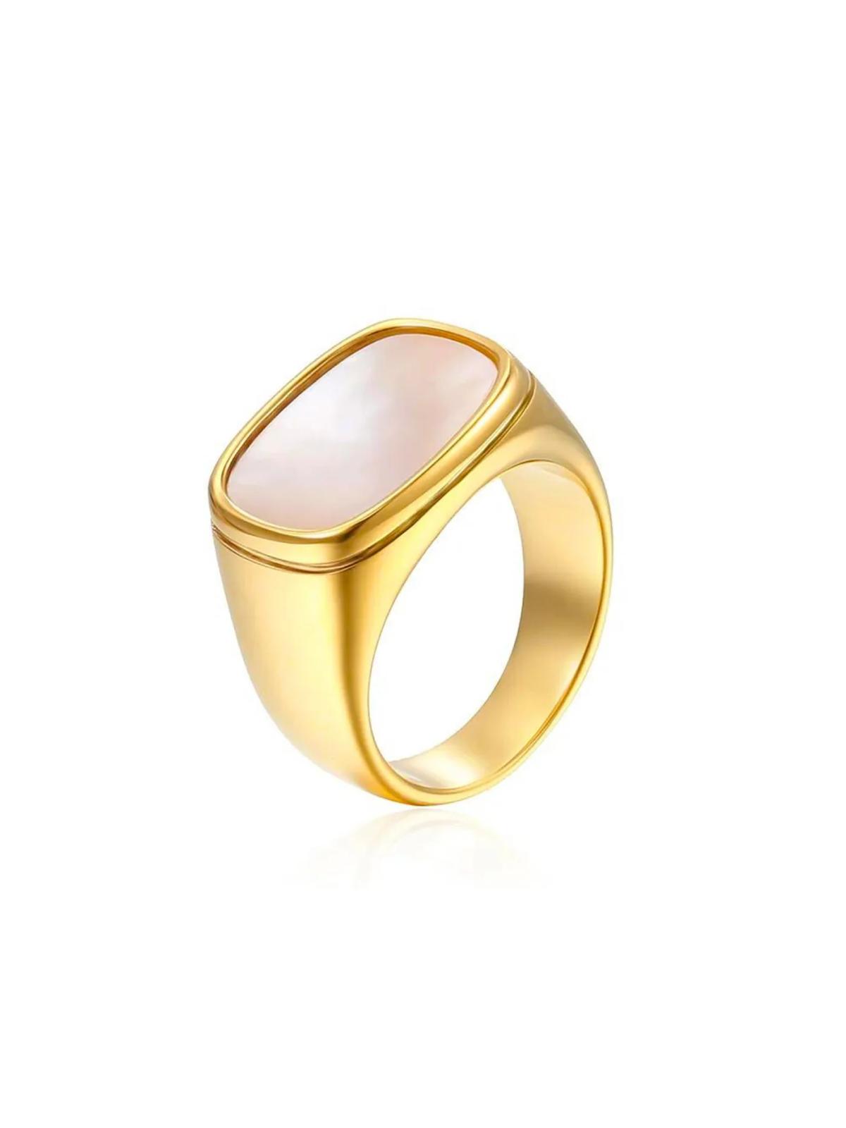 Gold white shell ring with a pink stone on a white background