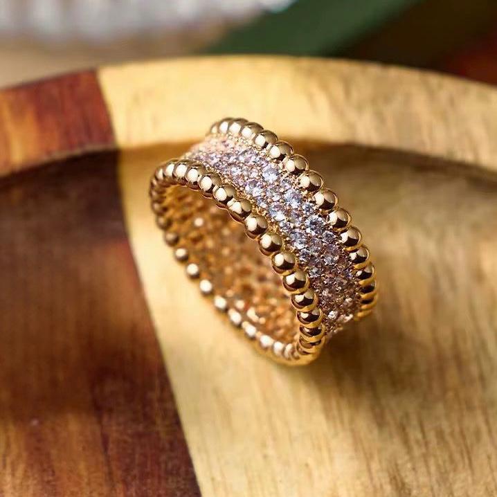 Gold ring with diamond accents on a wooden surface